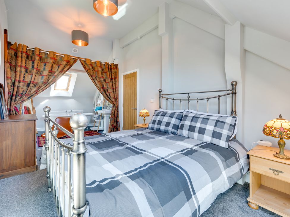 A bedroom with a bed and lamps at Birchover Chapel in Birchover