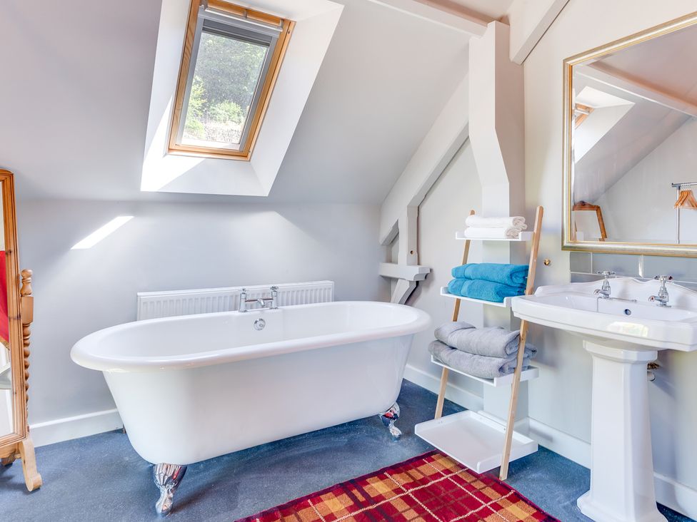 A bathroom with a bathtub and sink at Birchover Chapel, Birchover