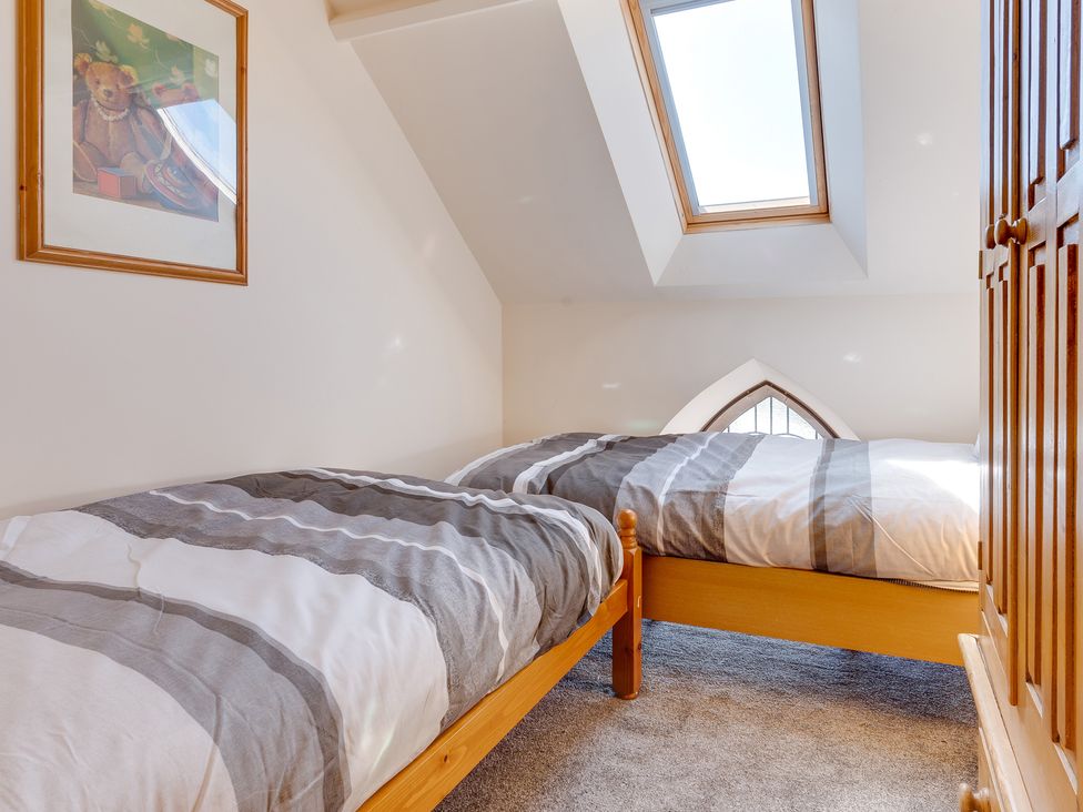 A bedroom with two beds and a skylight at Birchover Chapel in Birchover