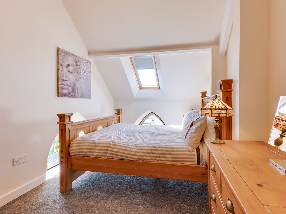 A bedroom with a bed and a dresser at Birchover Chapel in Birchover