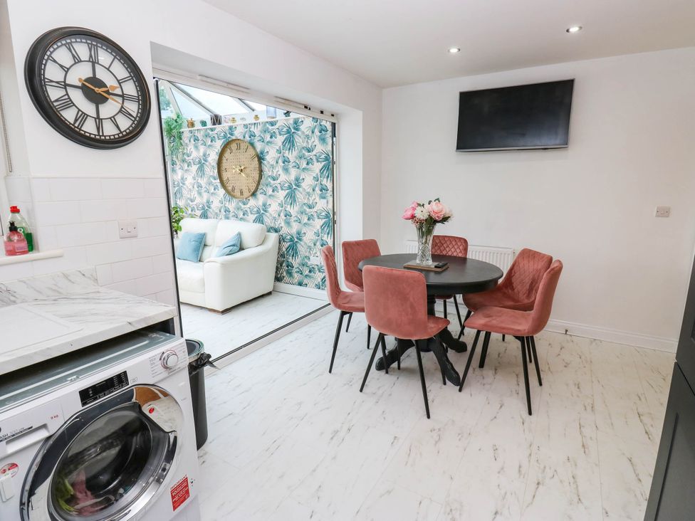 A dining room with a table and chairs at Canal House in Shipley