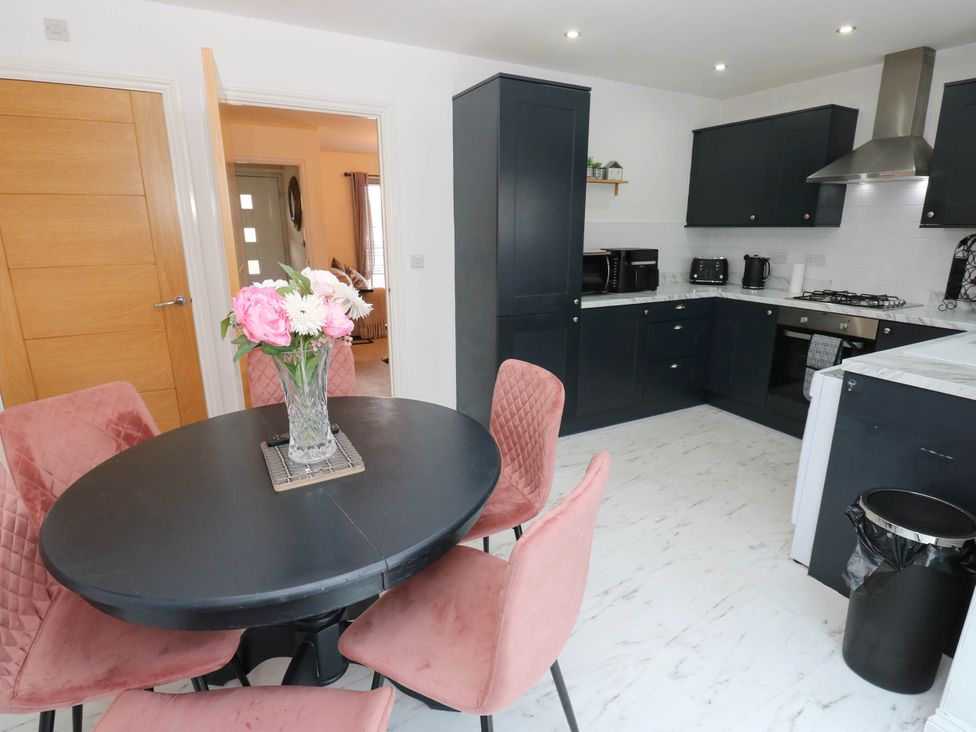 A kitchen with a round table and chairs at Canal House in Shipley