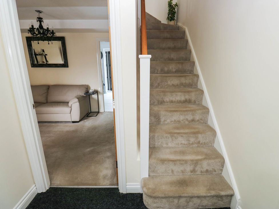 A hallway with stairs and a sofa at Canal House in Shipley