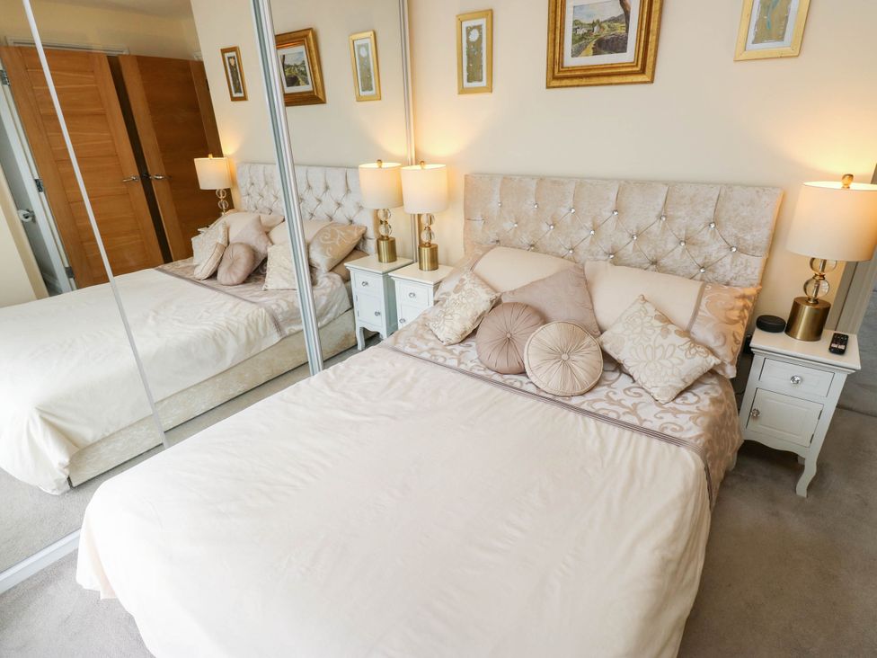 A bedroom with a bed and nightstands at Canal House, Shipley