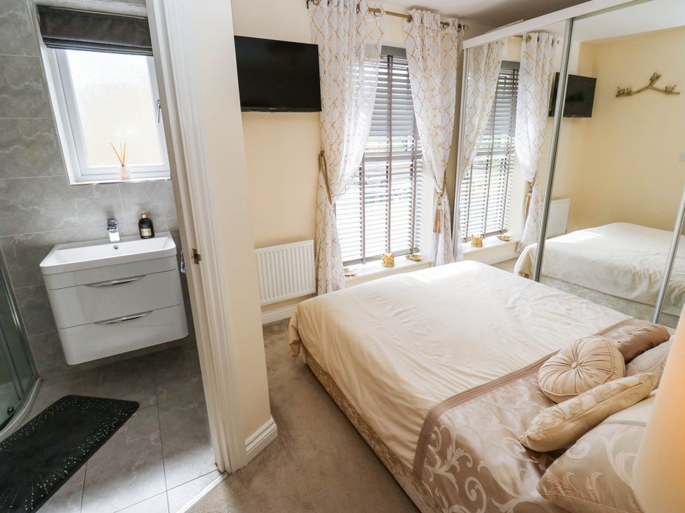 A bedroom with a bed, window, and sink at Canal House in Shipley