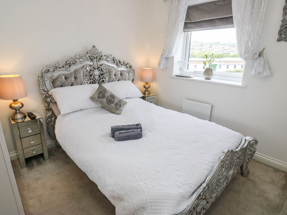 A bedroom with a bed and nightstand at Canal House in Shipley