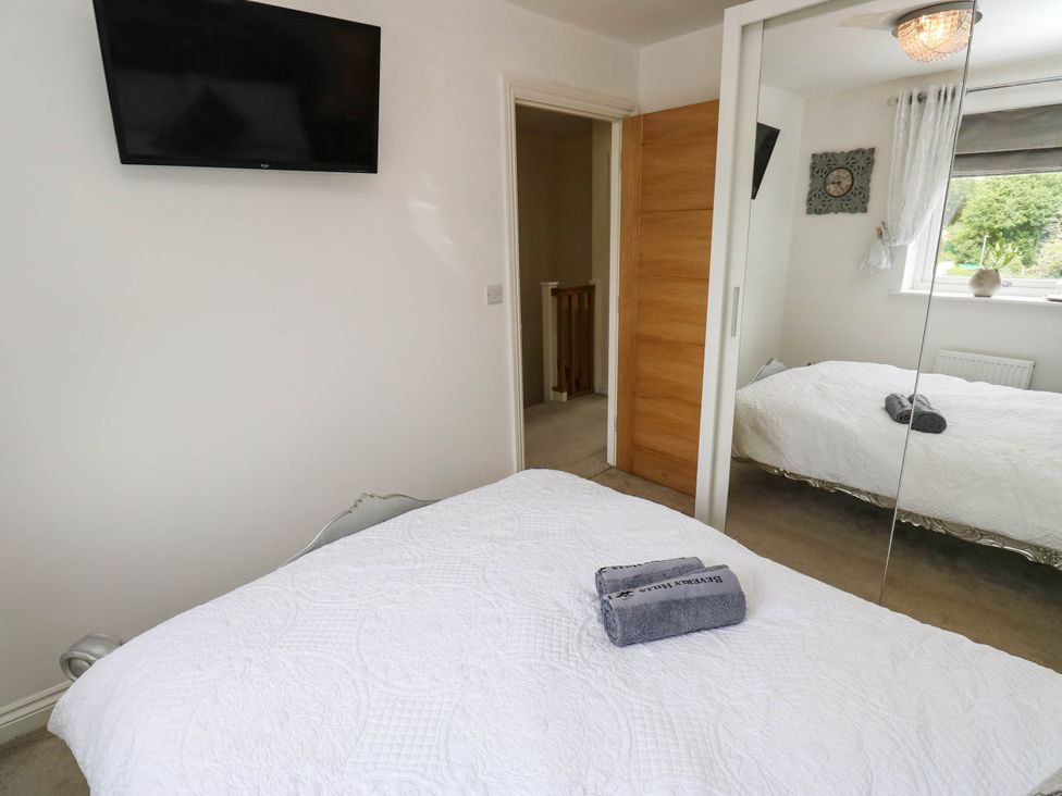 A bedroom with a bed and television at Canal House in Shipley