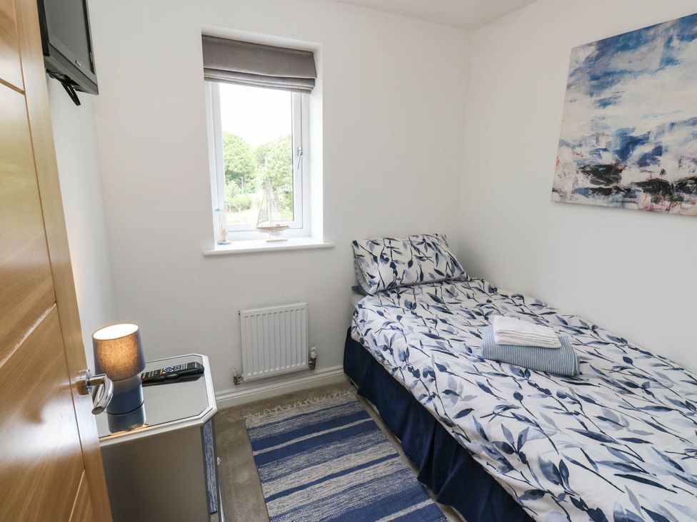 A bedroom with a bed and a television at Canal House in Shipley