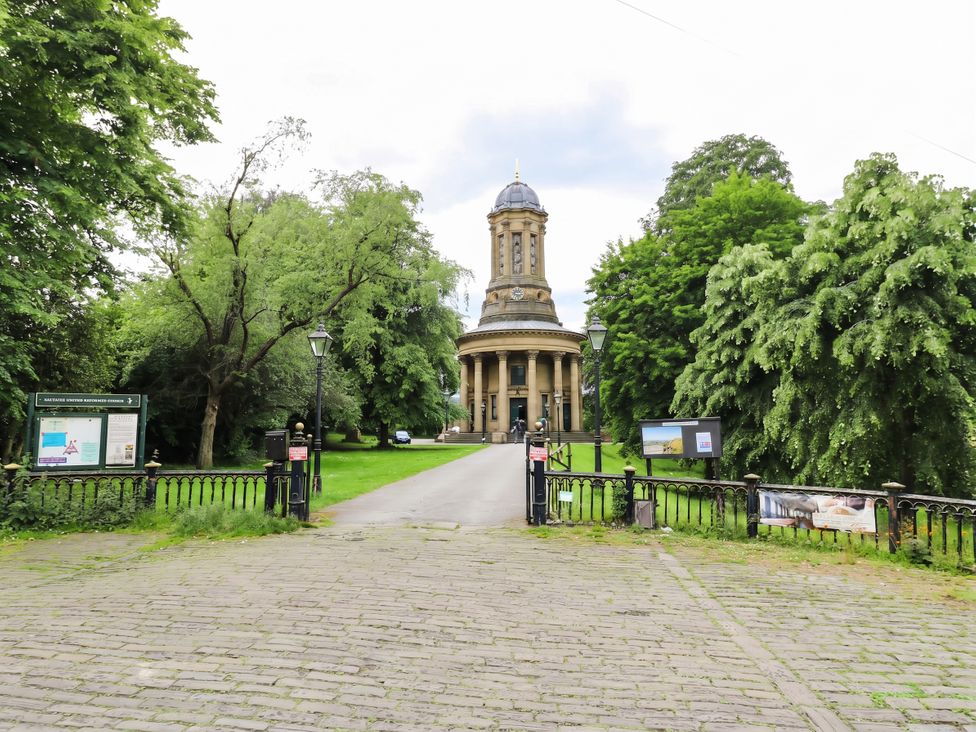 A view of a tower with trees and an information board at Canal House in Shipley