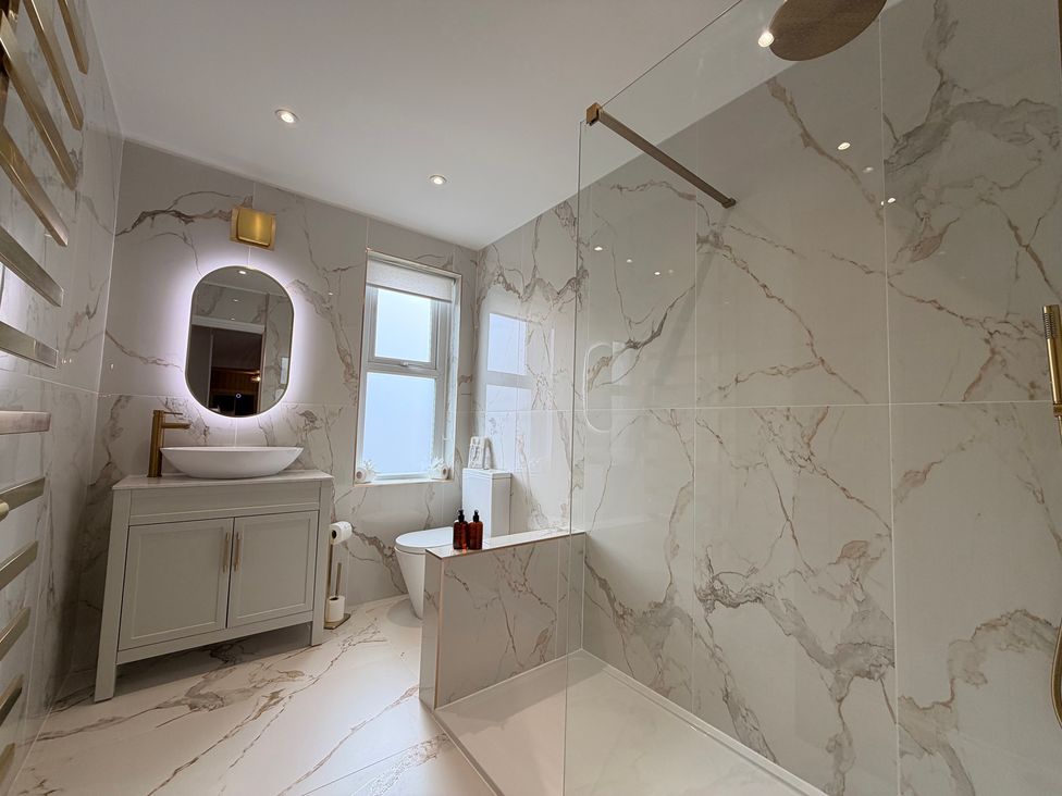 A bathroom with a bathtub and sink at Number 8 in Llandudno