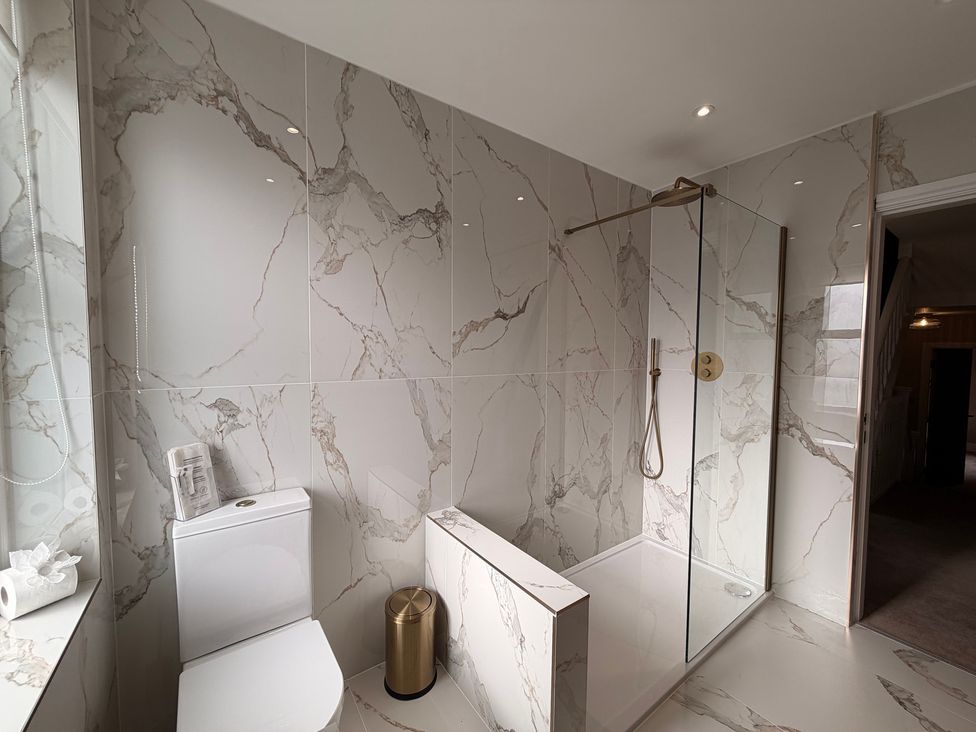 A bathroom with a shower and toilet at Number 8 Llandudno
