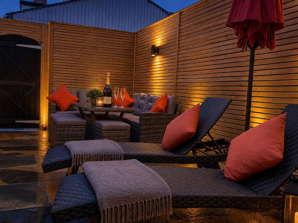 An outdoor seating area with a table and chairs at Number 8 in Llandudno