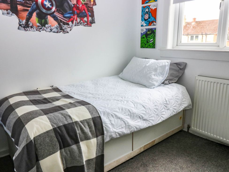 A bedroom with a bed and wall art at 6 Niddrie Marischal Road, Edinburgh