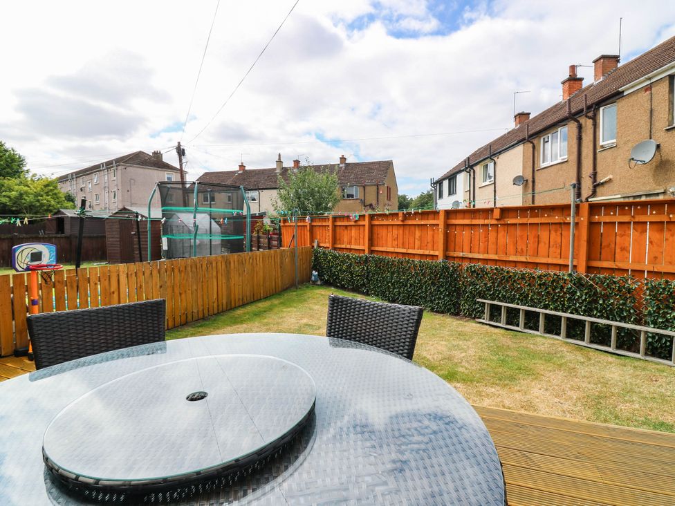 A garden with a table and chairs at 6 Niddrie Marischal Road in Edinburgh