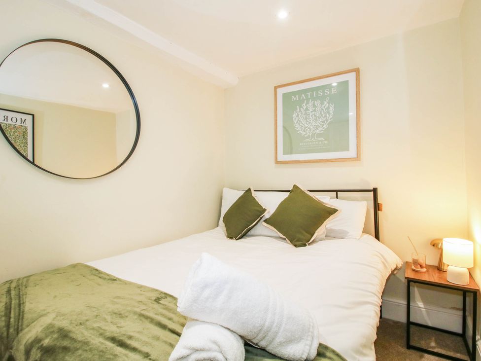 A bedroom with a bed and artwork at The Annex at The Lodge in Shawbury