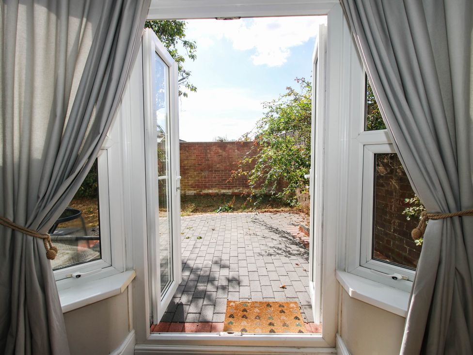 A patio view from inside with open doors at The Annex at The Lodge Shawbury