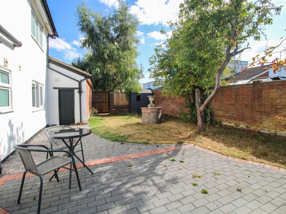 A garden with a table and chair at The Annex at The Lodge in Shawbury
