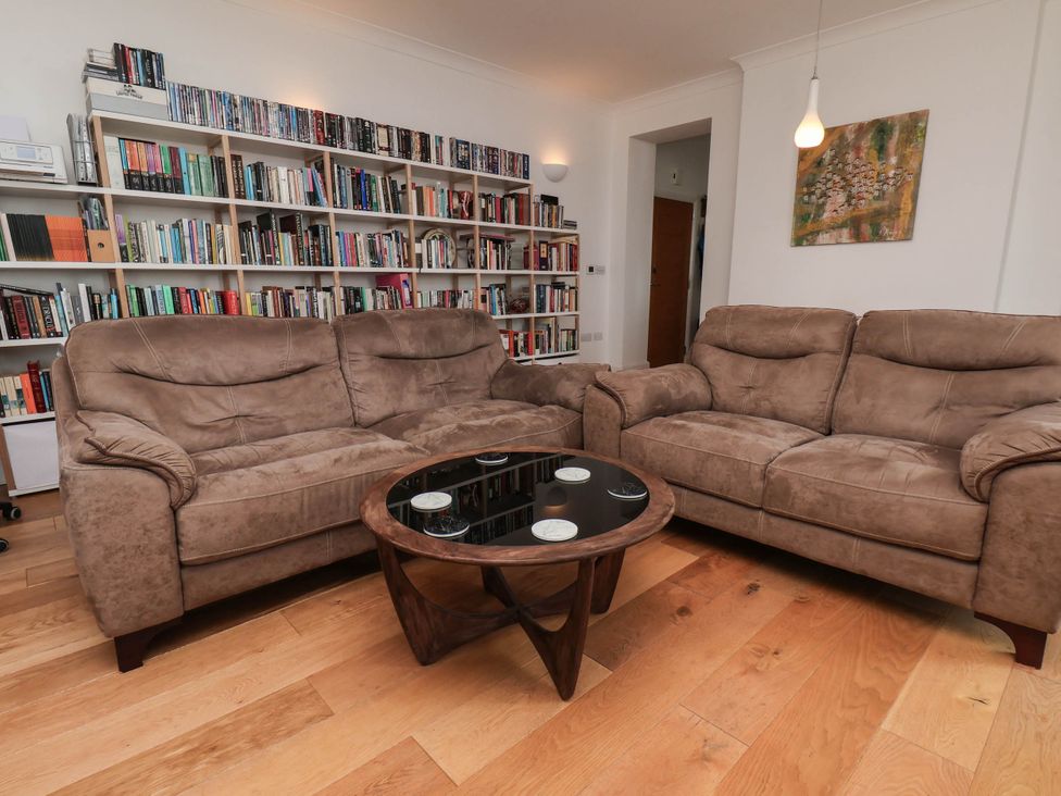 A living room with a sofa and coffee table at 26 Metropole Towers in Whitby