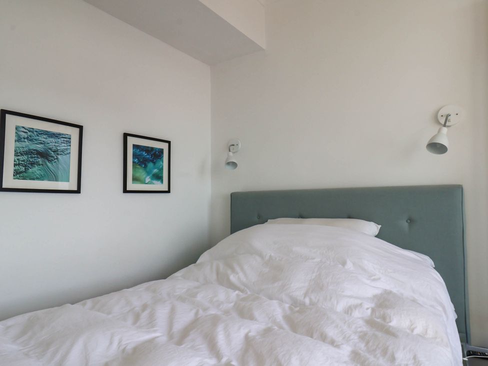 A bedroom with a bed and wall art at 26 Metropole Towers in Whitby