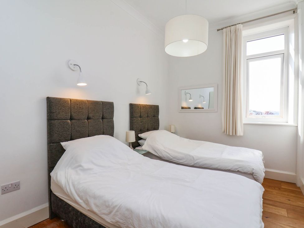 A bedroom with two beds and a window at 26 Metropole Towers in Whitby