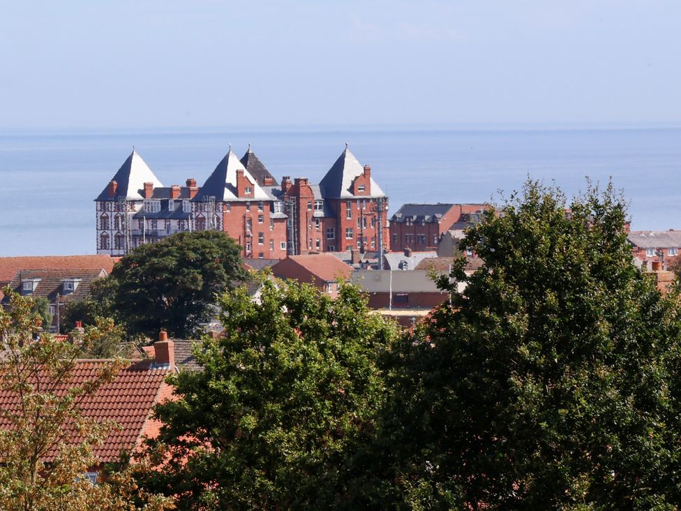 A view of buildings and trees with the sea in the background at 26 Metropole Towers Whitby
