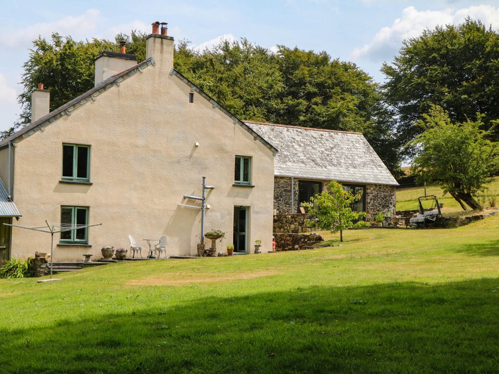 A house with a garden and trees at Little Moorgate in Okehampton