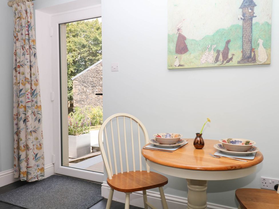 A dining room with a table and chairs at Little Moorgate in Okehampton