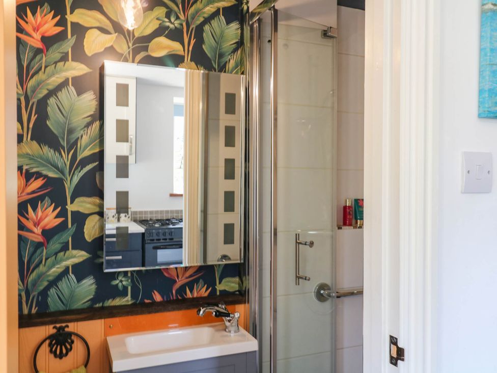 A bathroom with a sink and shower at Little Moorgate in Okehampton