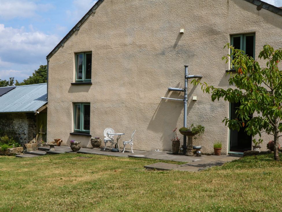 A house exterior with plants and furniture at Little Moorgate in Okehampton
