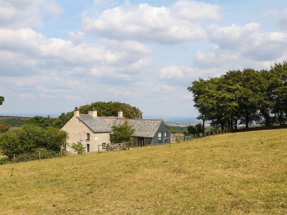 A house in a field surrounded by trees at Little Moorgate in Okehampton