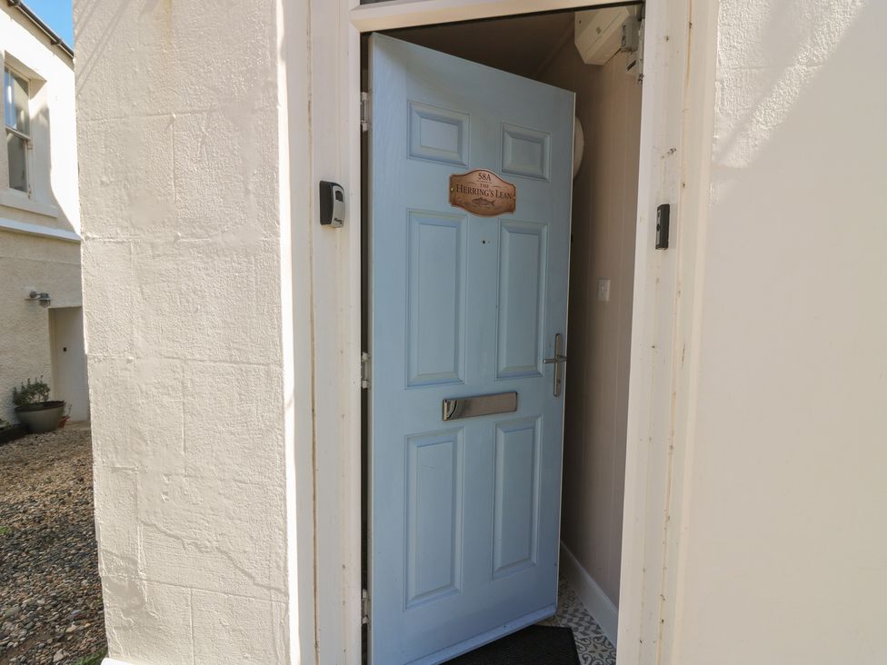 An entrance door with a nameplate at The Herring's Lean Eyemouth