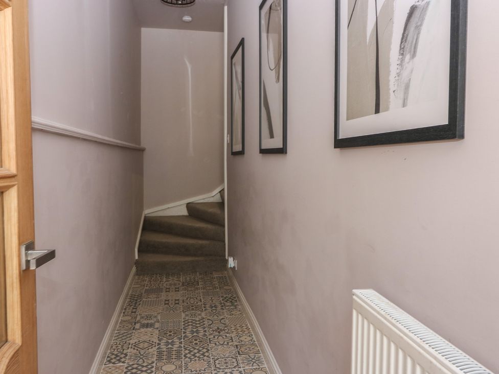 A hallway leading to stairs at The Herring's Lean in Eyemouth