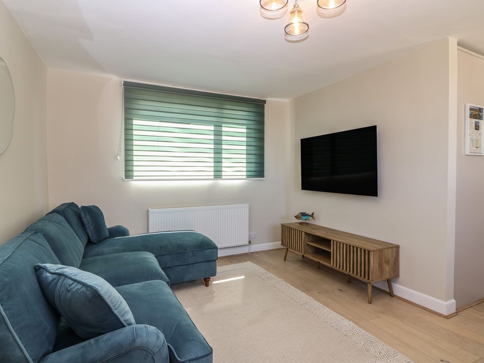 A living room with a sofa and television at The Herring's Lean in Eyemouth