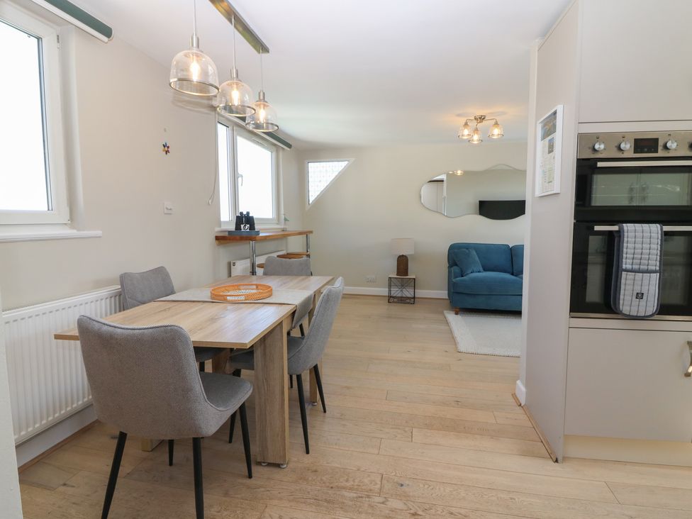 A dining room with a table and chairs at The Herring's Lean in Eyemouth