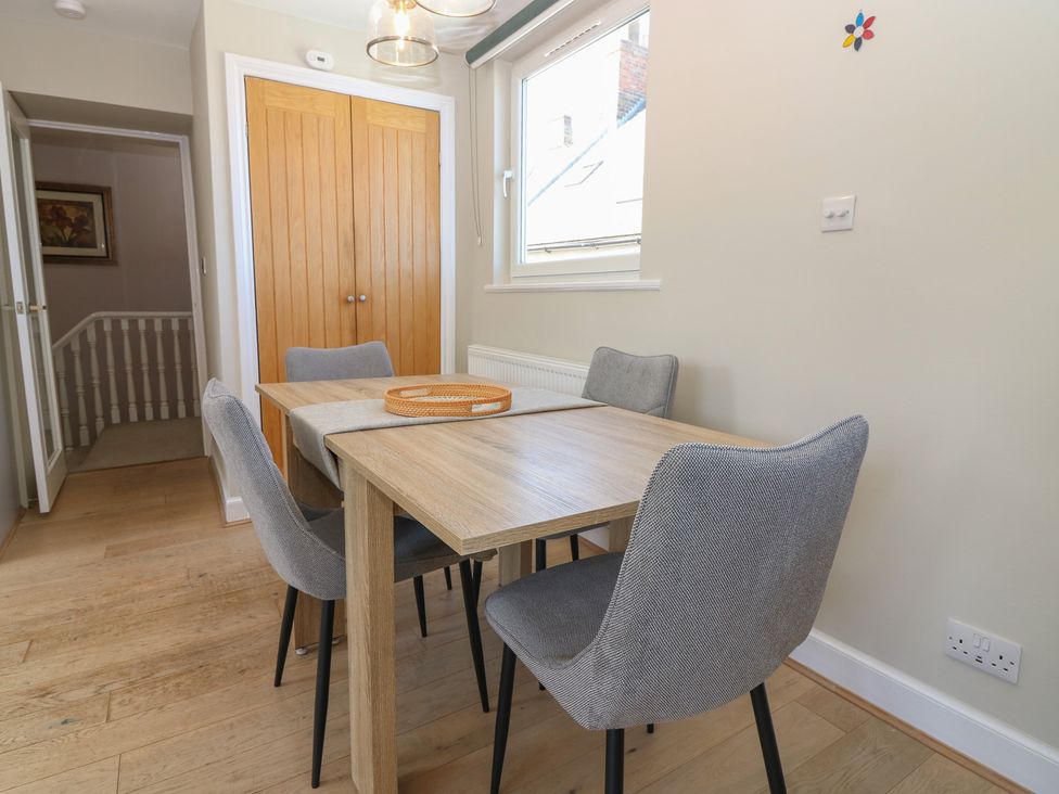A dining room with a table and chairs at The Herring's Lean in Eyemouth