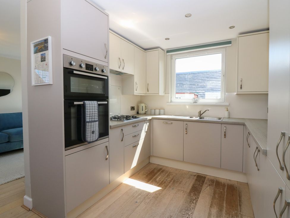 A kitchen with cabinets and a sink at The Herring's Lean in Eyemouth