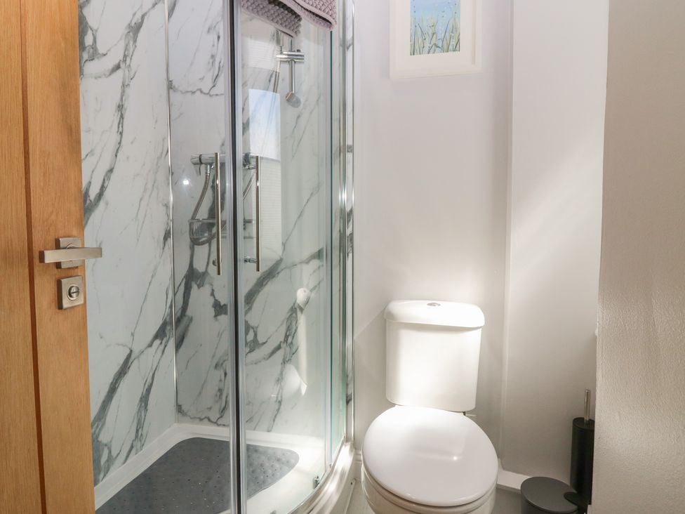 A bathroom featuring a shower and toilet at The Herring's Lean in Eyemouth