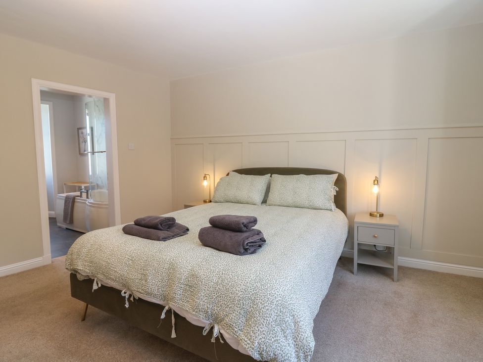 A bedroom with a bed and towels on it at The Herring's Lean in Eyemouth
