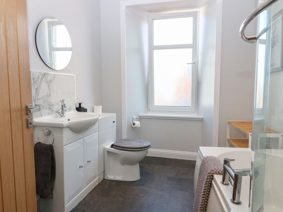 A bathroom with a bathtub and sink at The Herring's Lean in Eyemouth