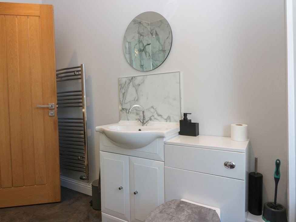 A bathroom with a sink and mirror at The Herring's Lean in Eyemouth