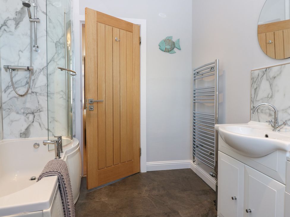 A bathroom with a bathtub and sink at The Herring's Lean in Eyemouth