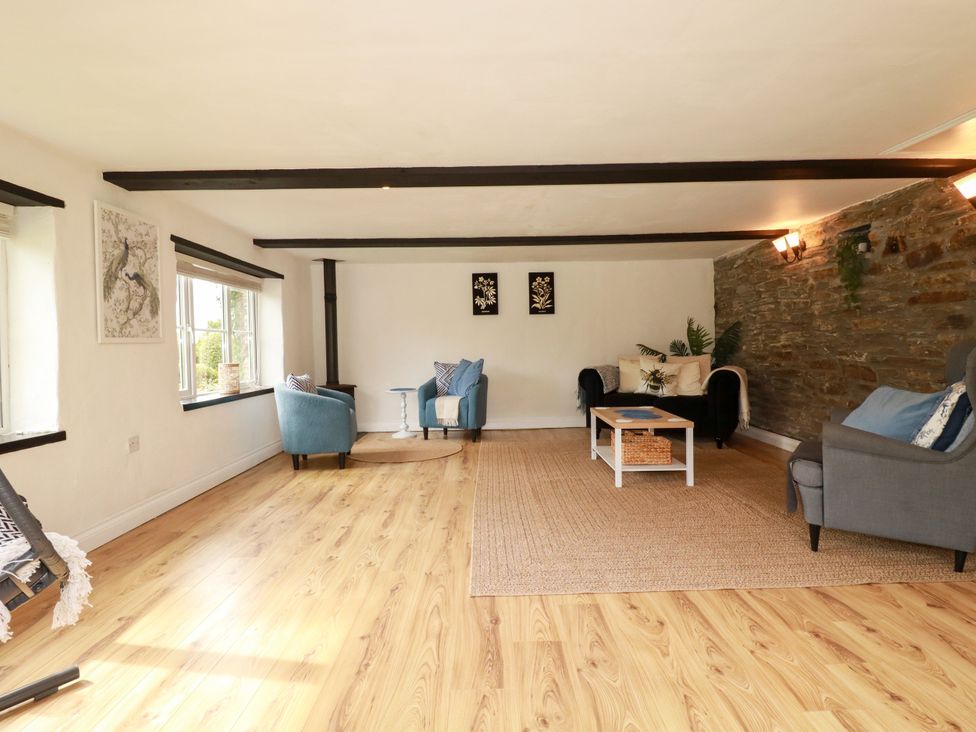 A living room with furniture and decor at Honey Bee Cottage Menheniot
