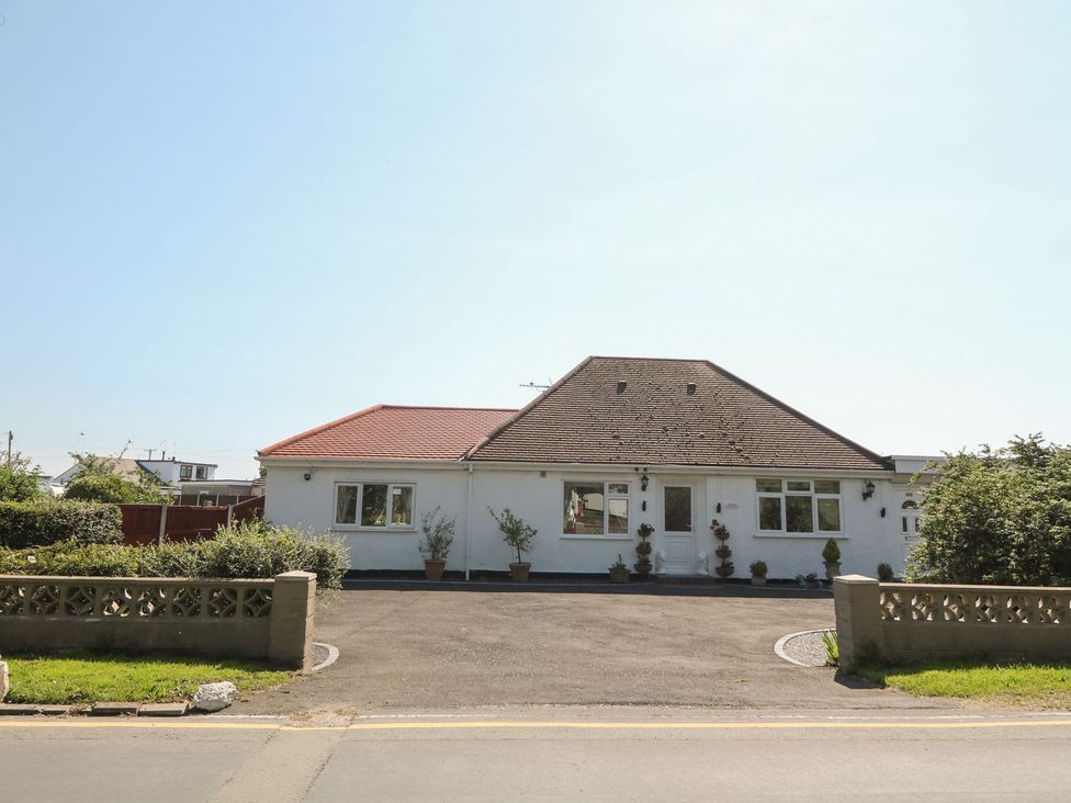 A house with a garden and driveway at Beachway in Holywell