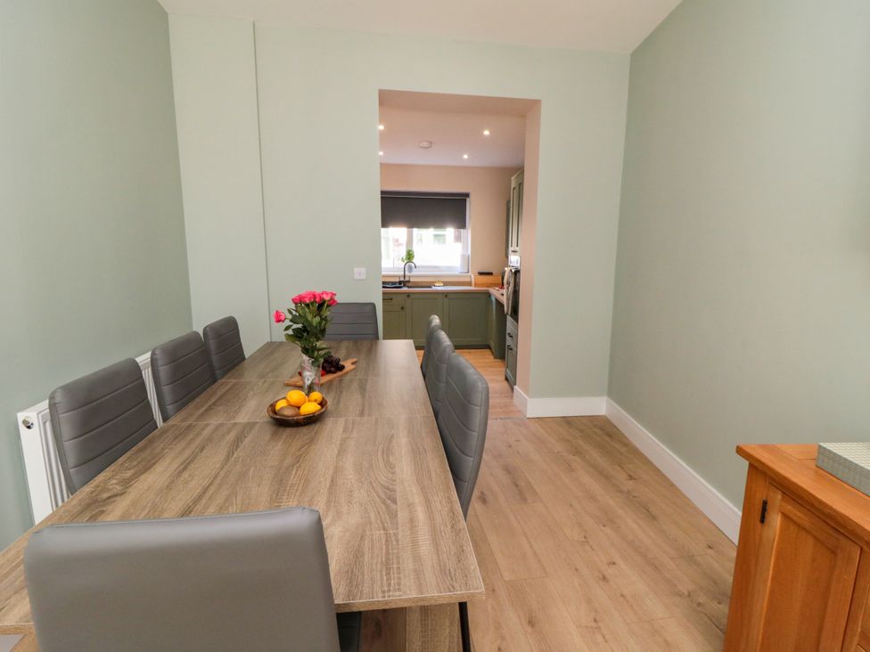 A dining room with a large table and chairs at Portobell House in Bridlington