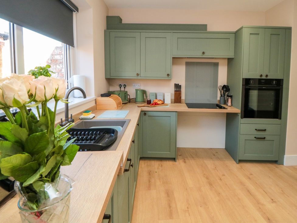 A kitchen with cabinets and countertop at Portobell House in Bridlington