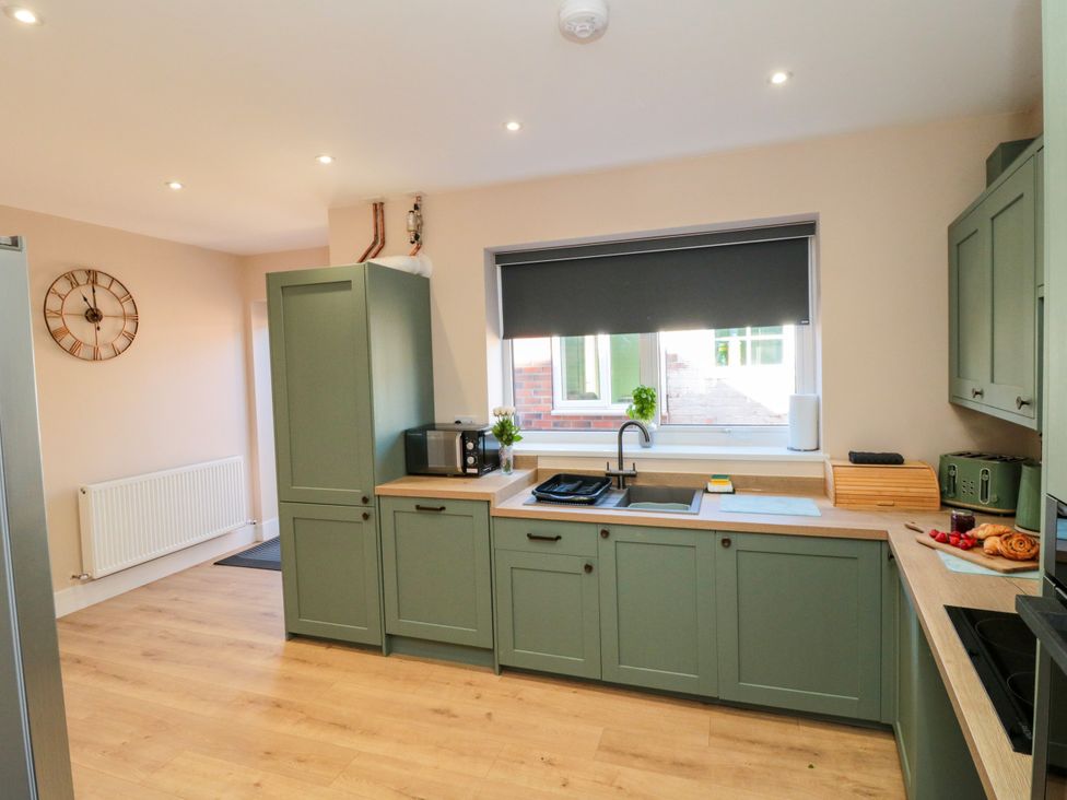 A kitchen with cabinets and appliances at Portobell House in Bridlington