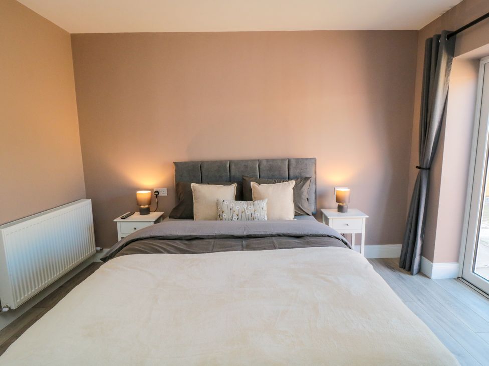 A bedroom with bed and bedside tables at Portobell House in Bridlington
