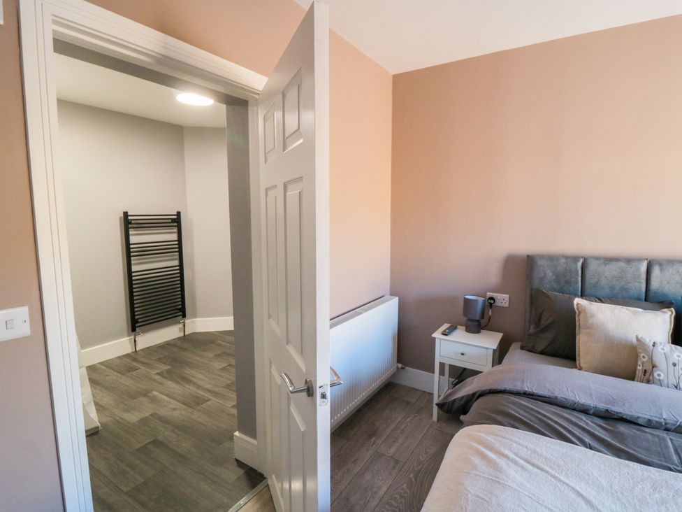 A bedroom with a bed and bedside table at Portobell House in Bridlington