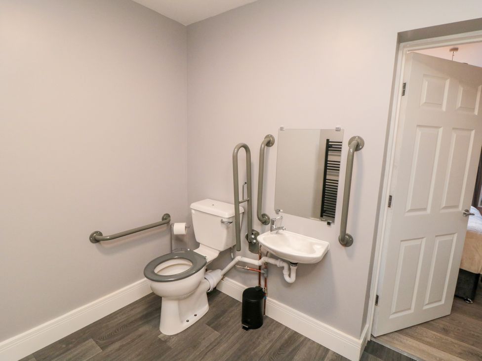 A bathroom with a toilet and sink at Portobell House in Bridlington