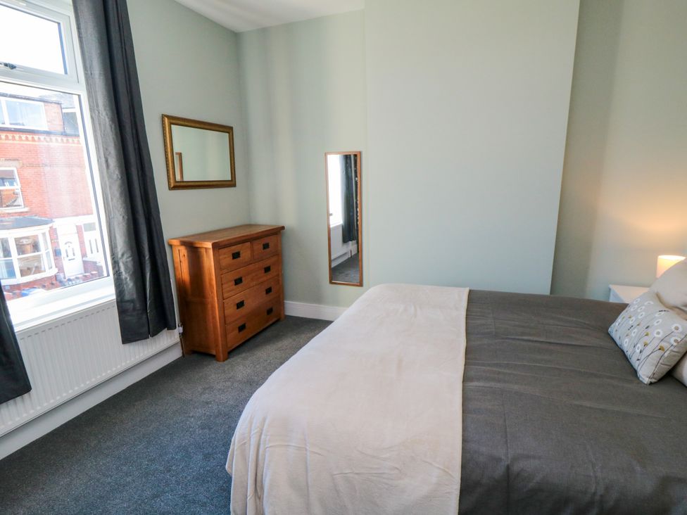 A bedroom with a bed and a chest of drawers at Portobell House in Bridlington